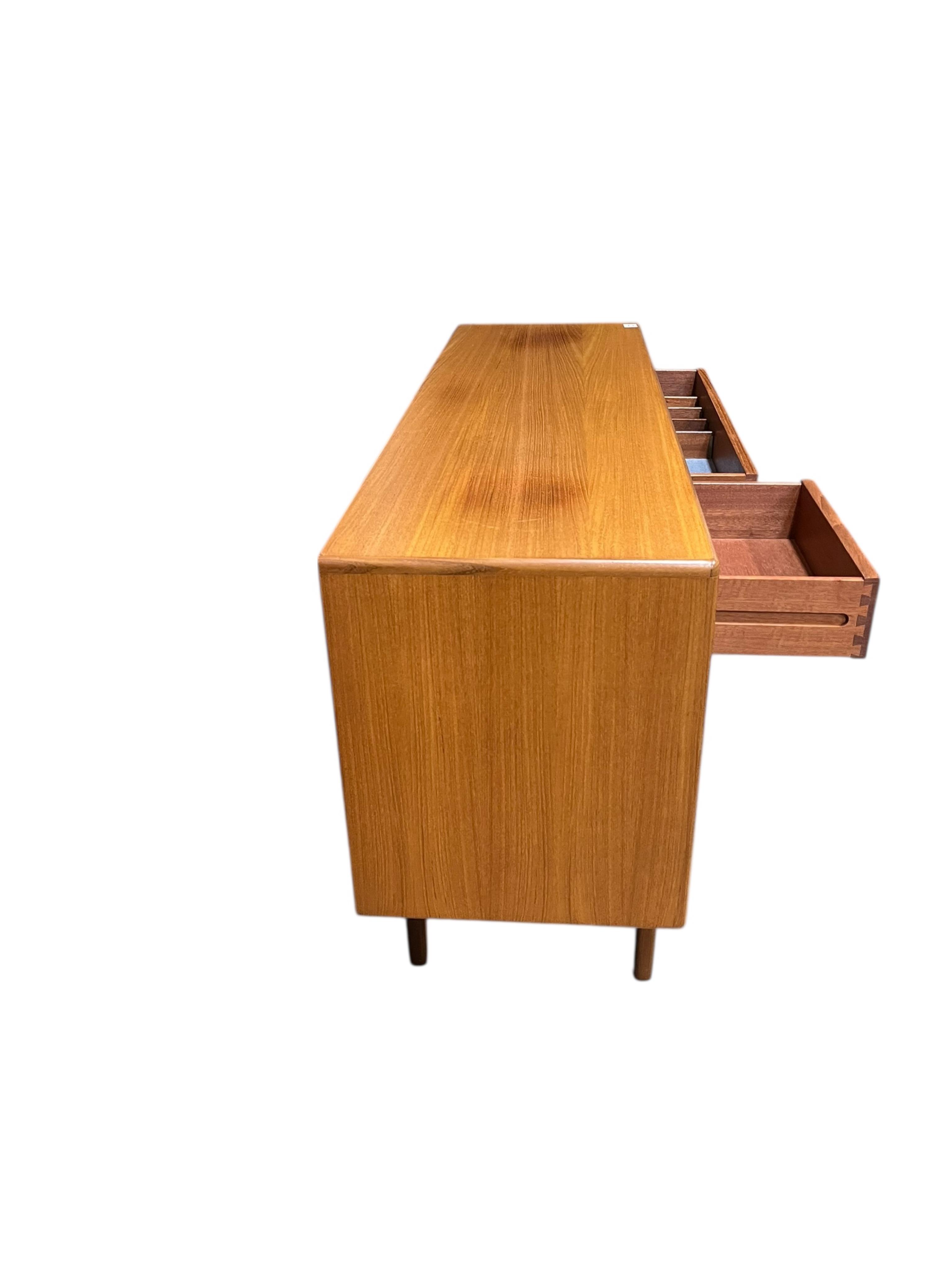 A mid century G Plan Fresco teak dining suite comprising dining table 184cm extended, depth 116cm, height 73cm, six chairs, two with arms and a four door sideboard, width 152cm